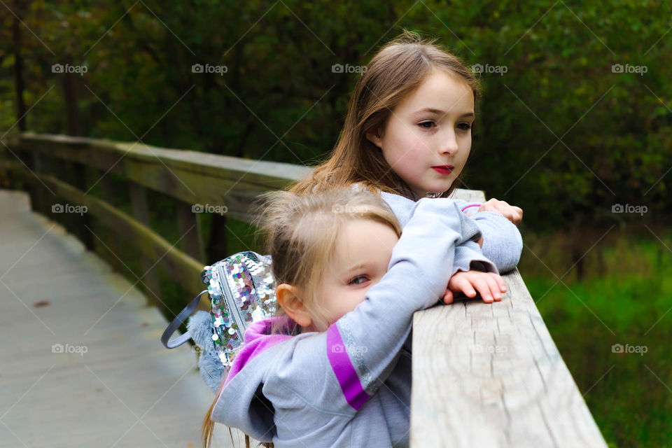 sisters on a bridge