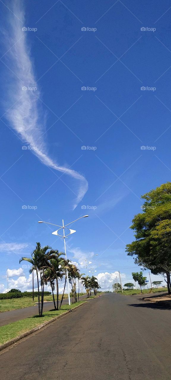 Strolling through the city on a clear day with a blue sky and watching the white clouds making designs in the sky!