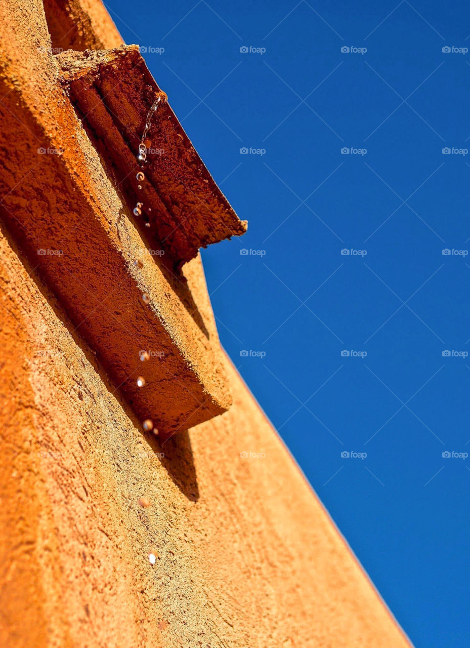 Water dripping from adobe house in Arizona