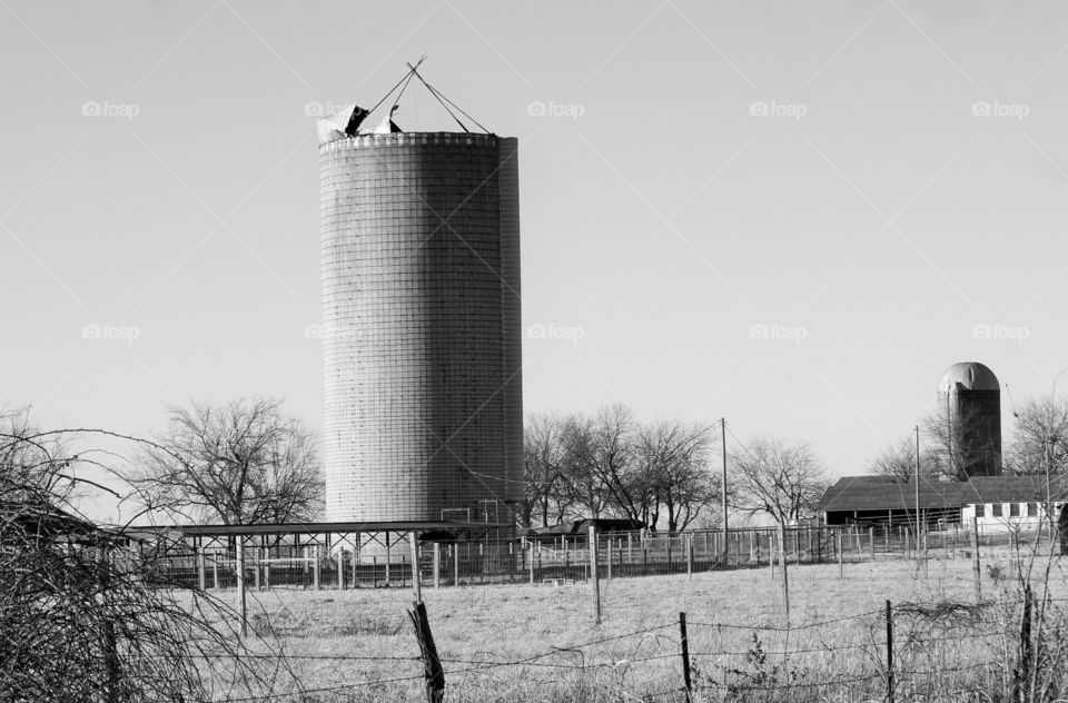 Feed tower in black & white. Photo taken on a farm in Oklahoma.  Feed tower in black and white.