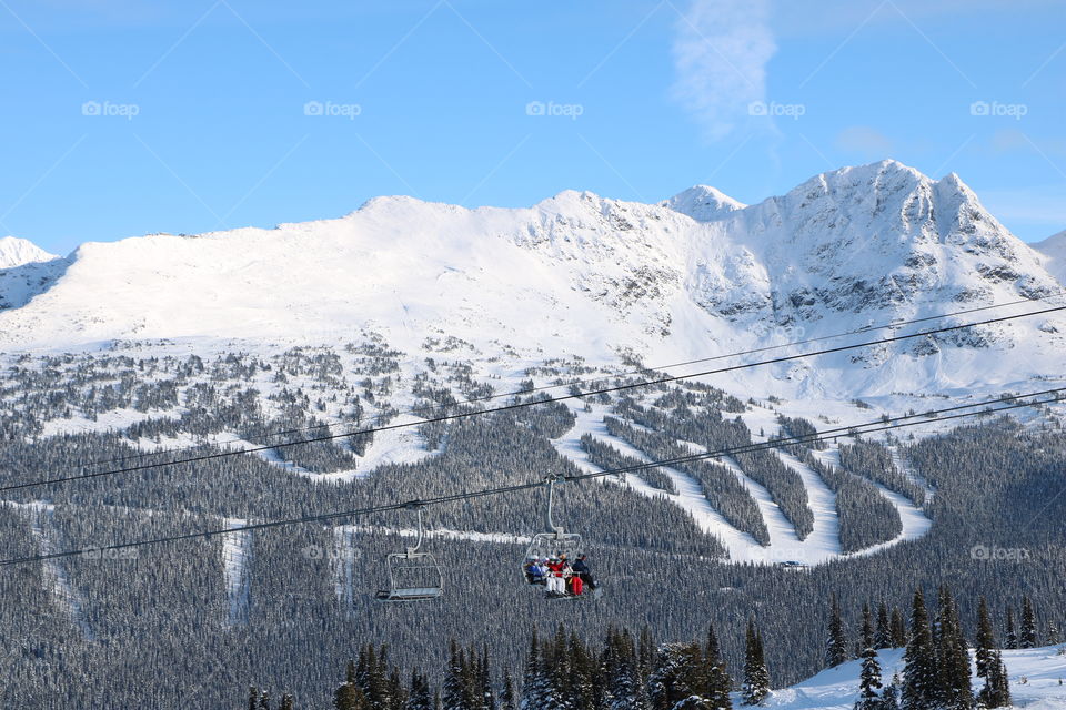 Blackcomb with trails , ski lifts and people enjoying the wintertime 