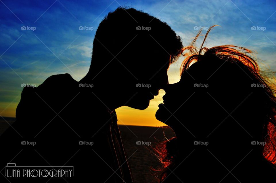 Lovers on the beach right before a kiss