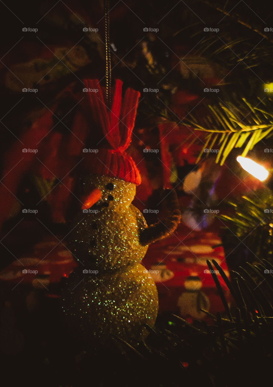 Glitter Snowman Christmas ornament hanging upon the Christmas tree.