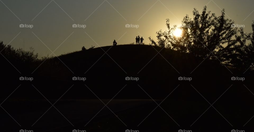 Early evening stroll on warm day in August, in Northala Fields. By darkening the exposure gave this image a beautiful silhouette of sunset and those enjoying the view. This was the smallest of the hills but the view from above was amazing. 