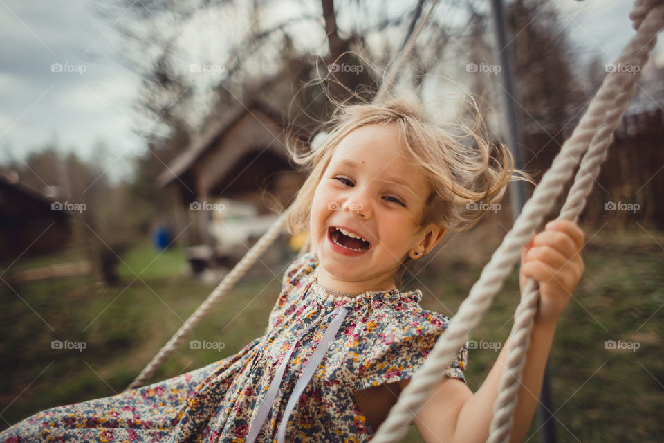 Little girl has fun on swing