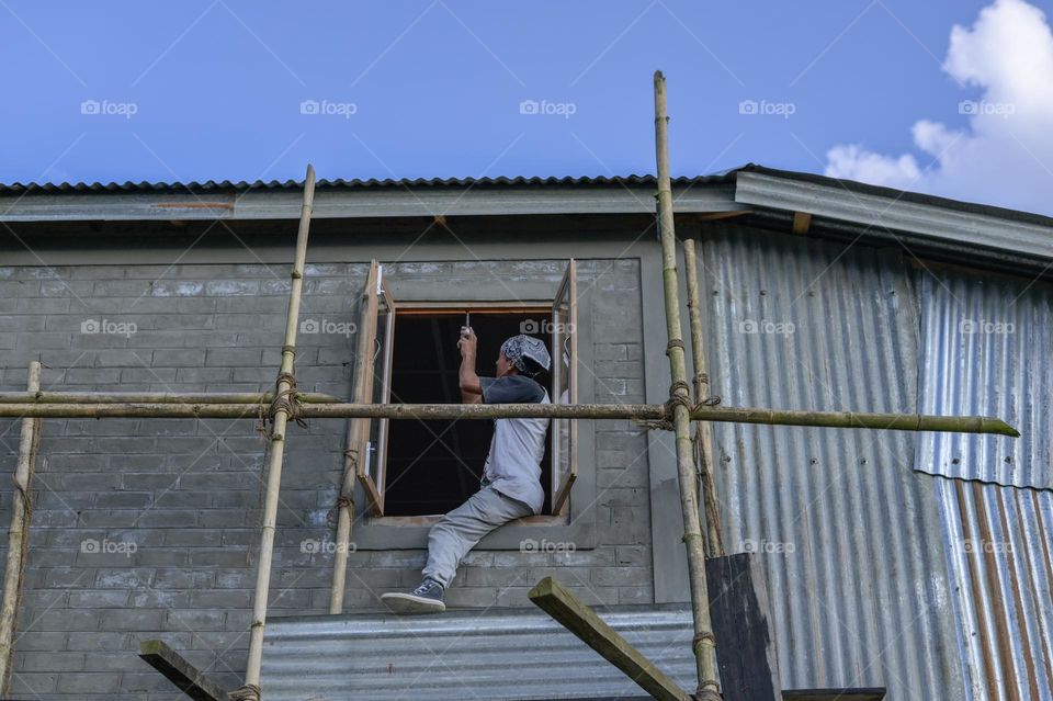 A carpenter doing window work