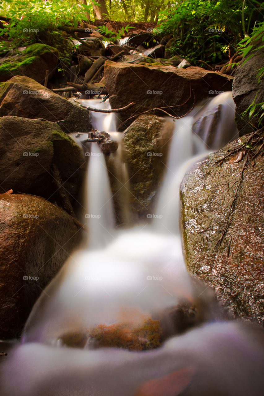 long exposure of water running over and down some rocks