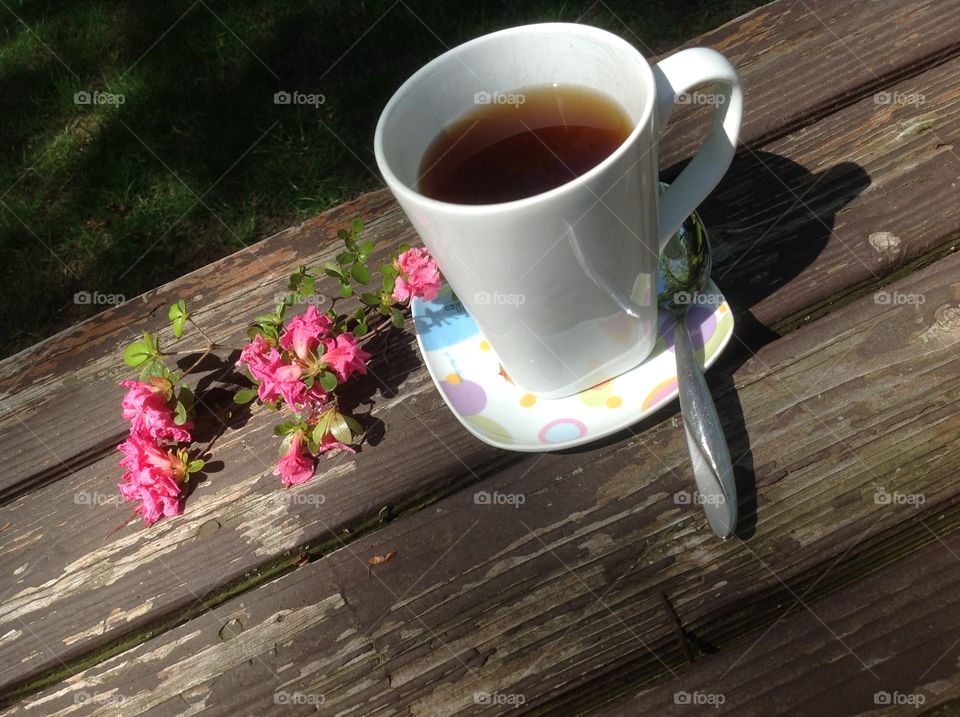 Enjoying a cup of coffee on a beautiful spring day outdoors.