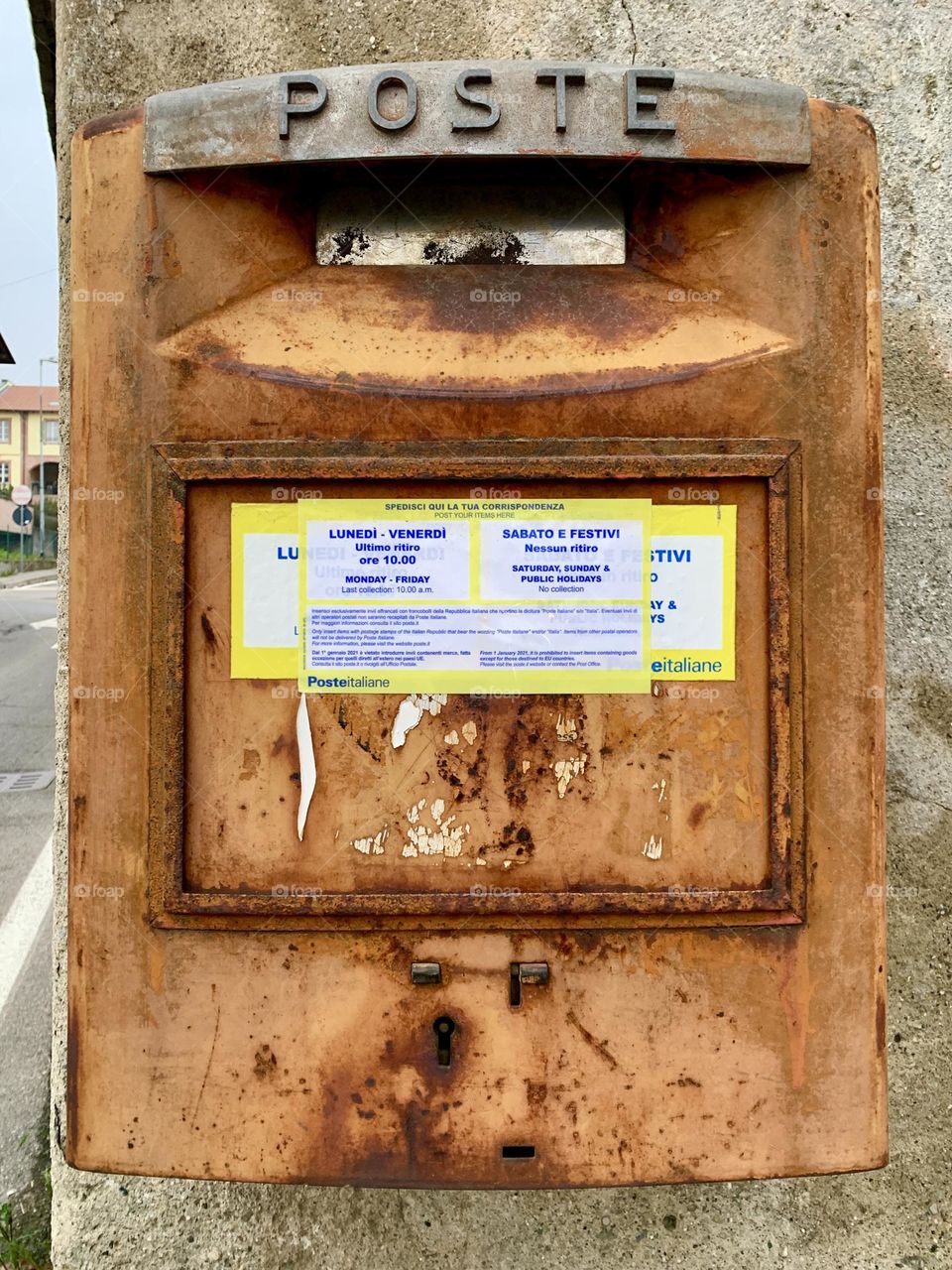 An old rusty mailbox still in use in a town in Lombardy