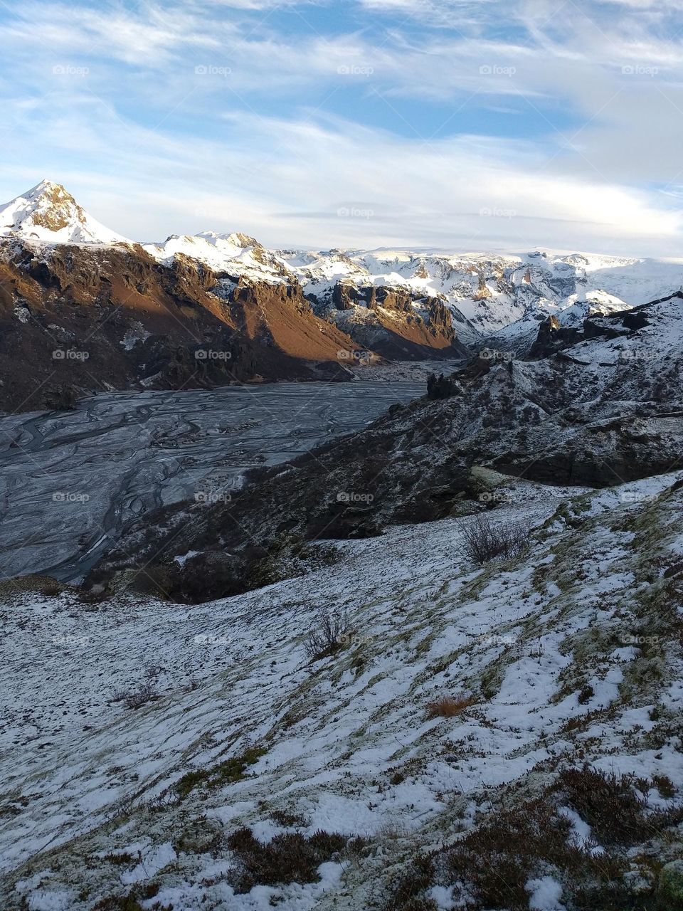Exploring the nature. Climbing snowy mountain range in Iceland.