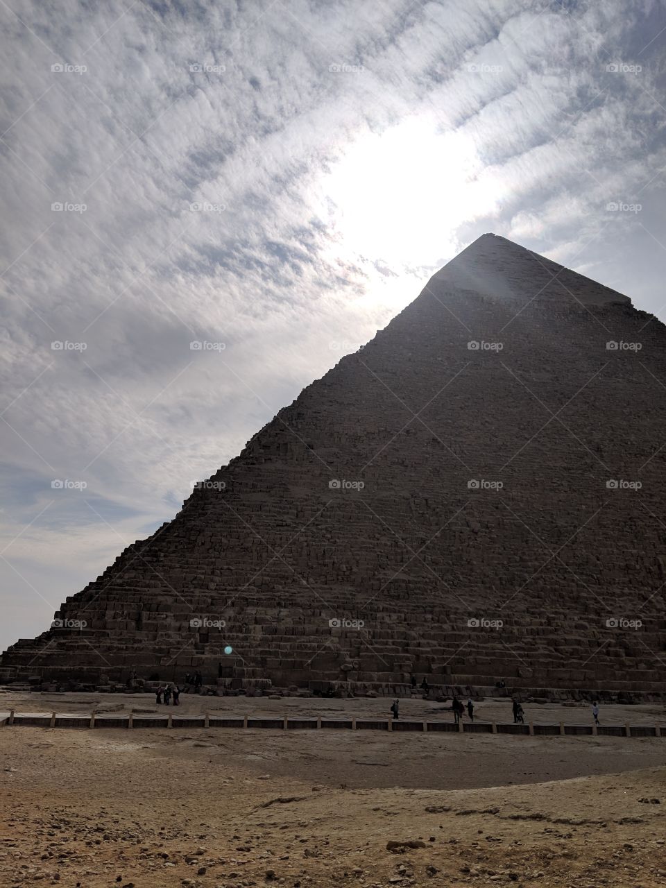 The sun going down behind the Pyramid of Khafre in Giza, Egypt