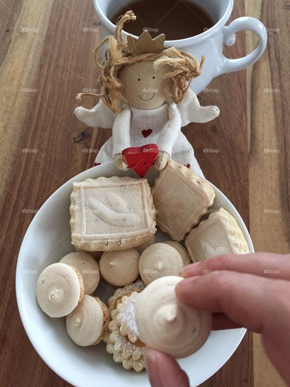 Cookies with guardian angel and cup of coffee