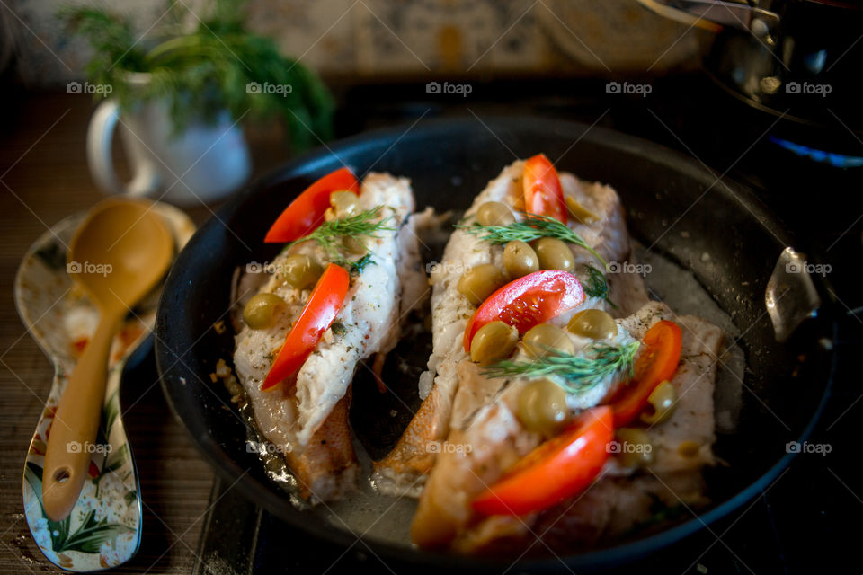 Dish with Sea bass fried with vegetables. grouper, Dish, Sea bass, fried, vegetables, tomato, olive, wooden, kitchen, cooking, cook, Mediterranean, fish
