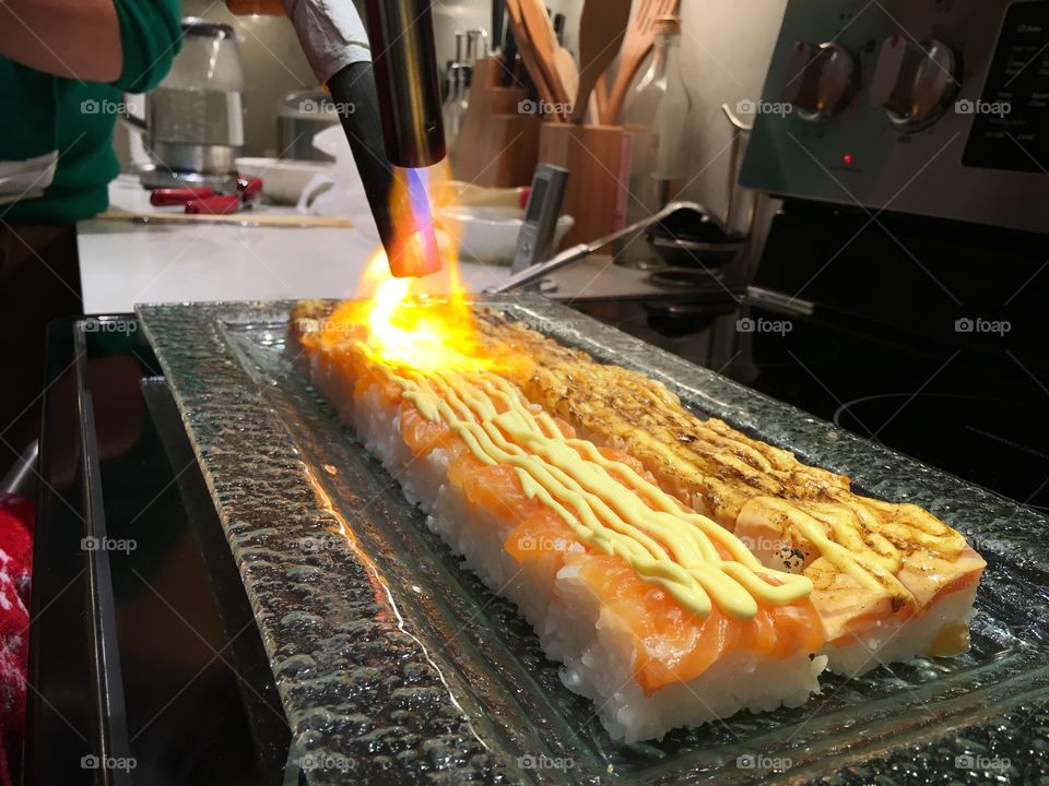 Salmon sushi blowtorched with charcoal. 