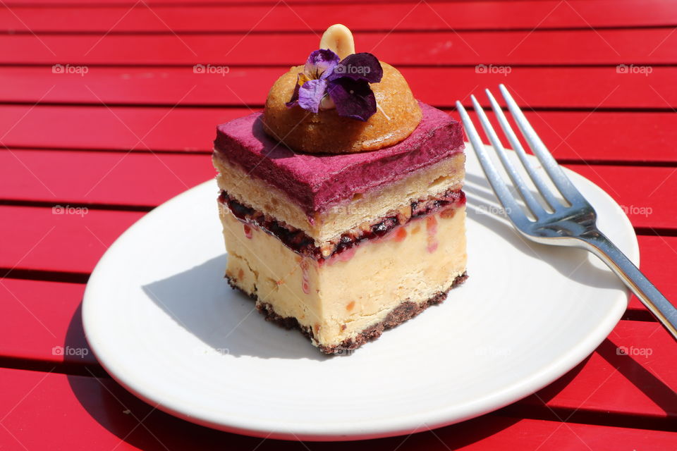 Fruity dessert in an white plate on a red wooden table ... waiting to be eaten..