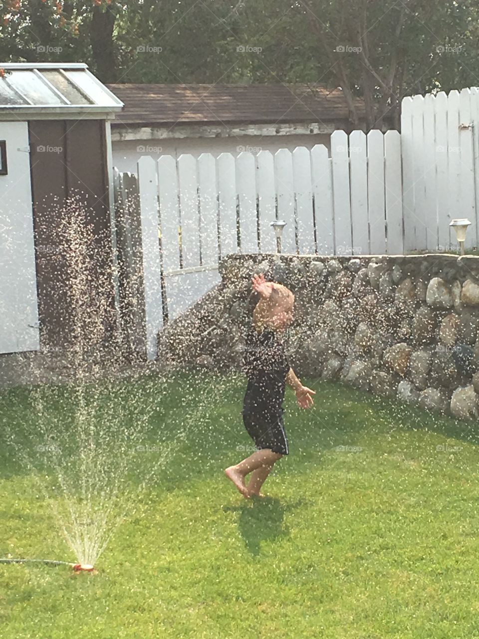 Running through the water sprinkler 