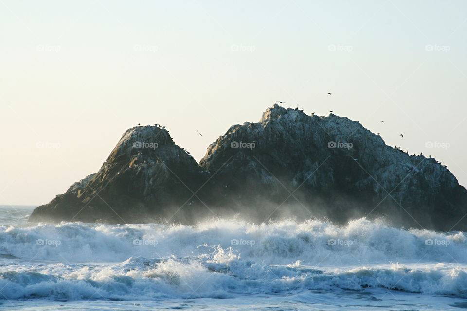 Rock island and wave