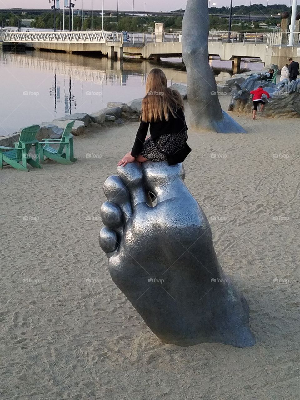 Girl on foot sculpture