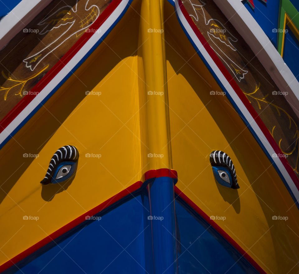 eyes on a bright colourful fishing boat in malta