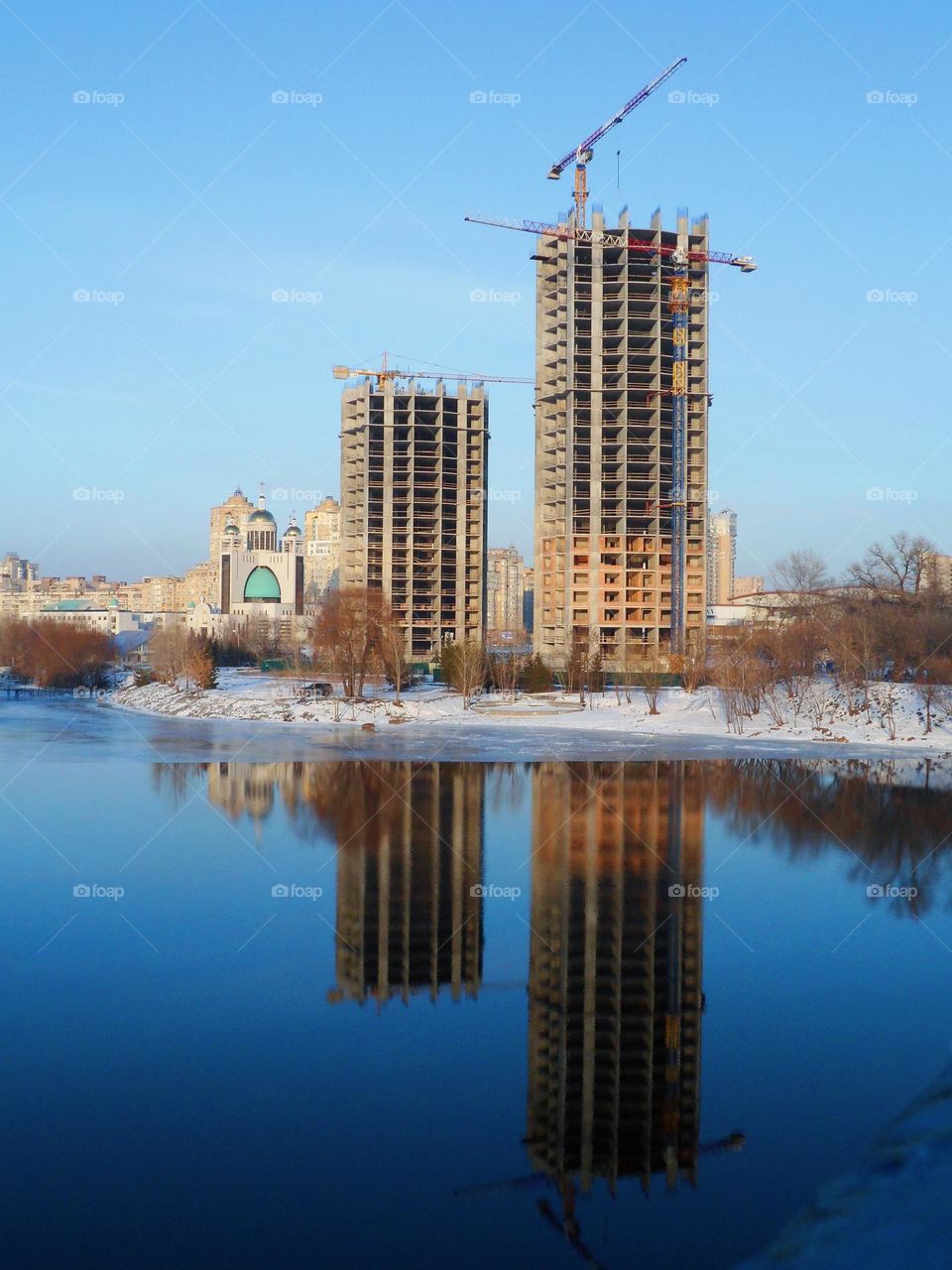 reflection in the water of unfinished buildings