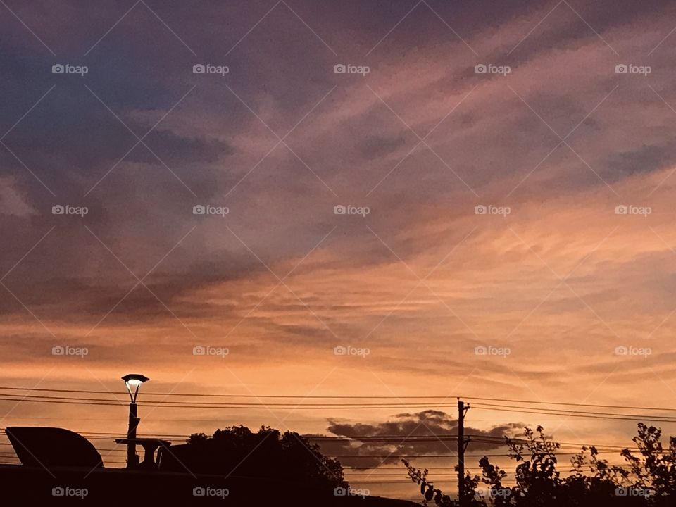 Wee Hours of a Beautiful Morning. Abstract Colors working there way up the cloud pattern. The sun slowly climbing its way to the Horizon for Sunrise.