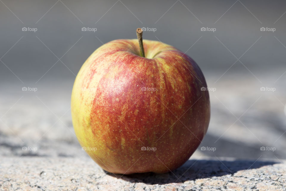 Close-up of apple on rock