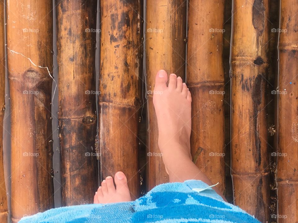 Feet on a hut over the water 