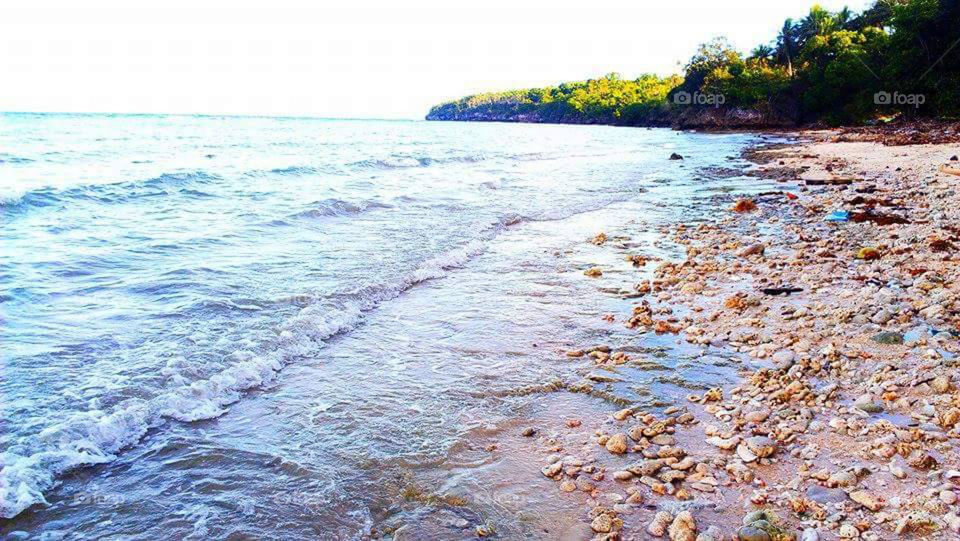 Seaside rocks on the tides. Enjoy browny colored tiny rocks and sand. Taken Bogo Maria Siquijor Province Philippines.