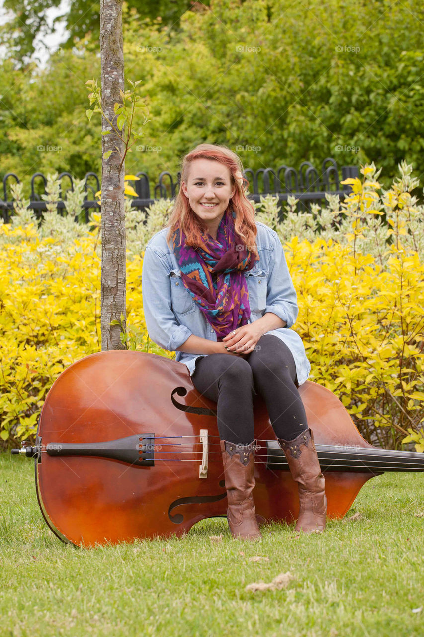 Girl sitting on a bass