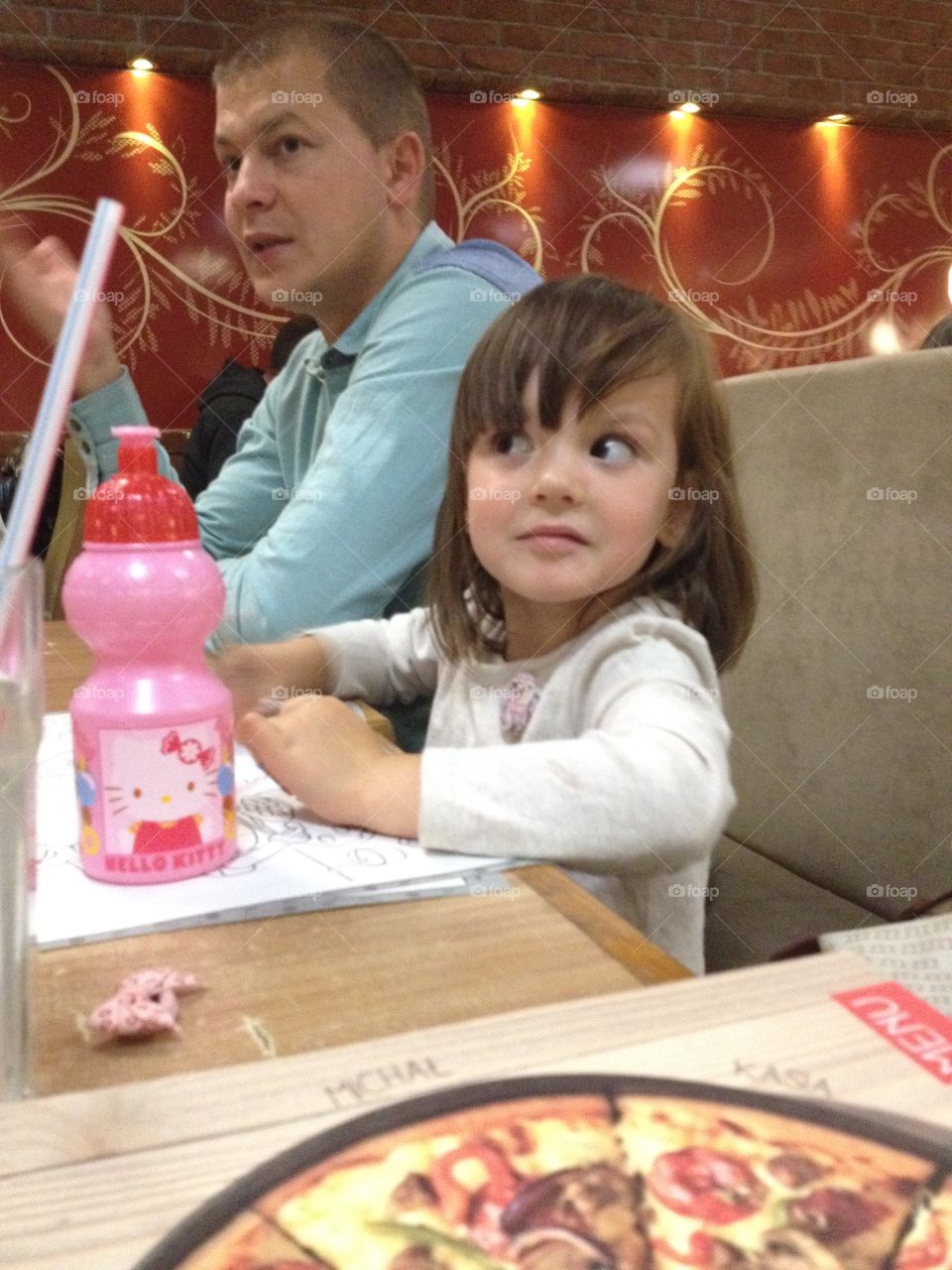 Father and daughter sitting in restaurant