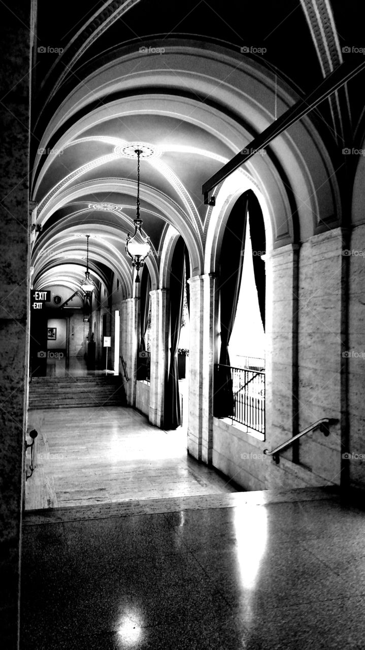hallway arches pendant lamp window marble floor