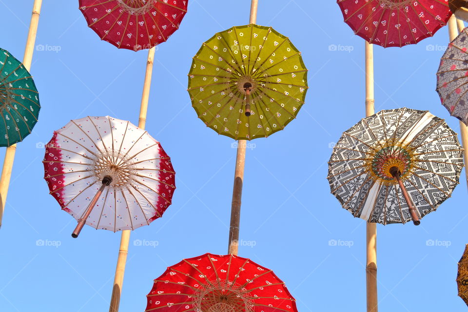 colorful umbrellas urban decoration over blue sky.