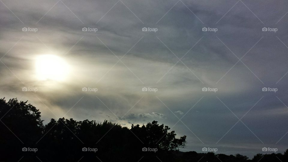 Flowing Sky. Sun behind clouds