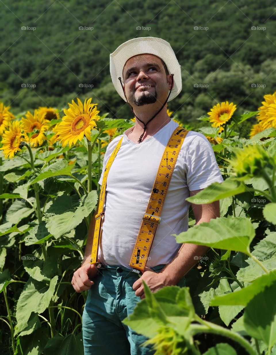 Hot man into the rural sunflower fields