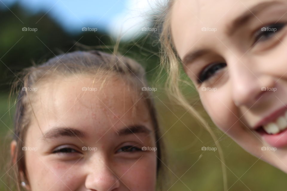 Close-up of two sisters smiling