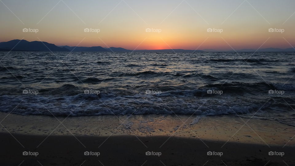Surf at beach during sunset