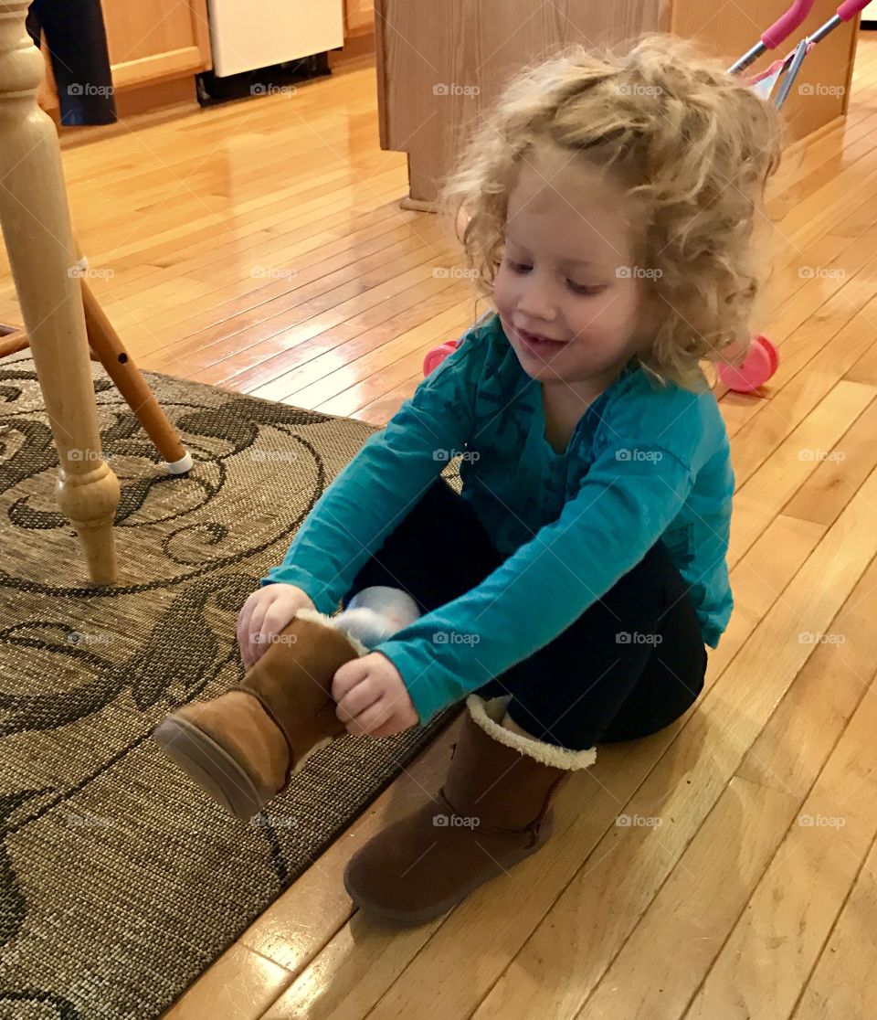 Toddler putting on shoes