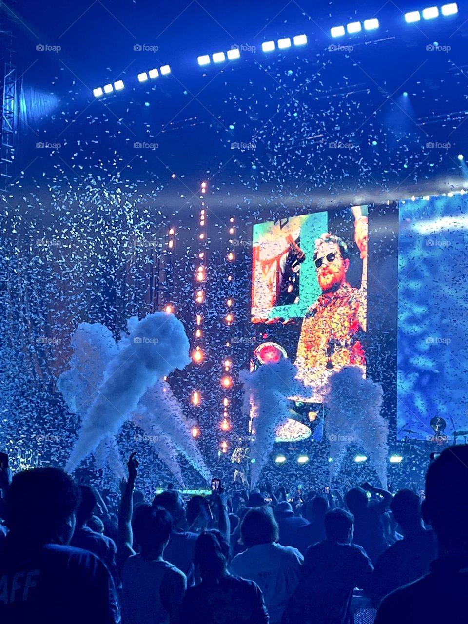 Confetti and smoke going off at a rock concert 