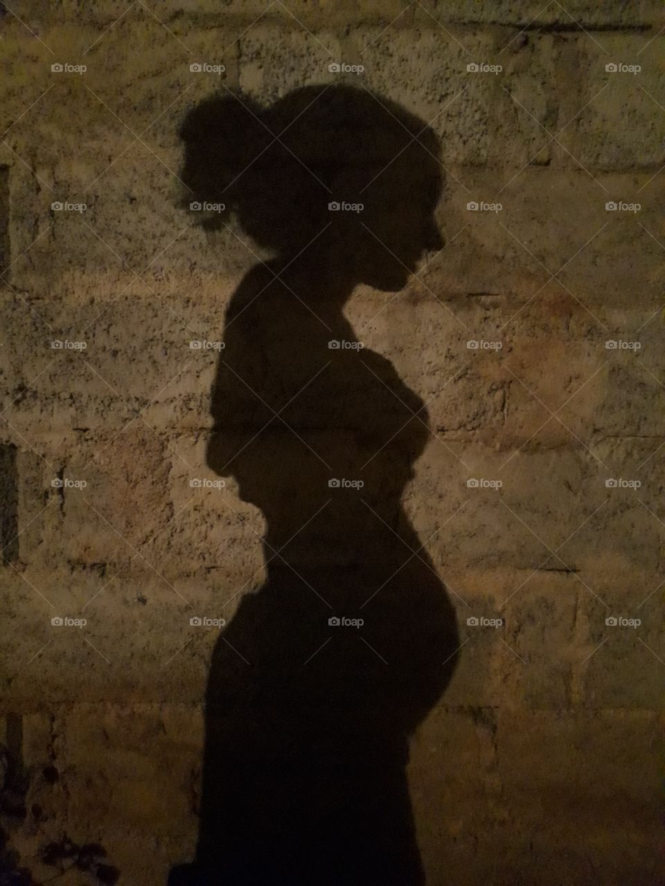 pregnant woman shadow in the night