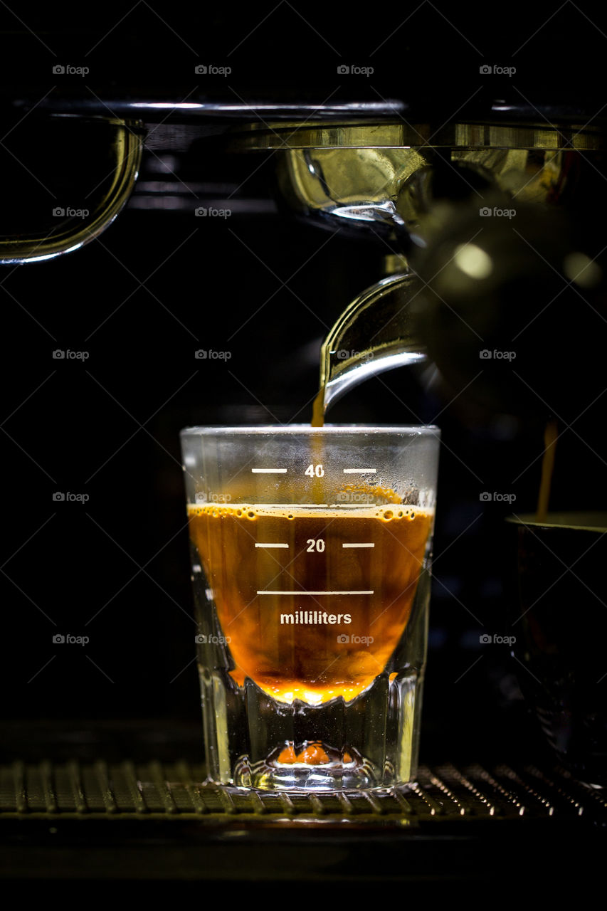 I love to make coffee! Image of espresso shot being made at home. Coffee pouring into glass.