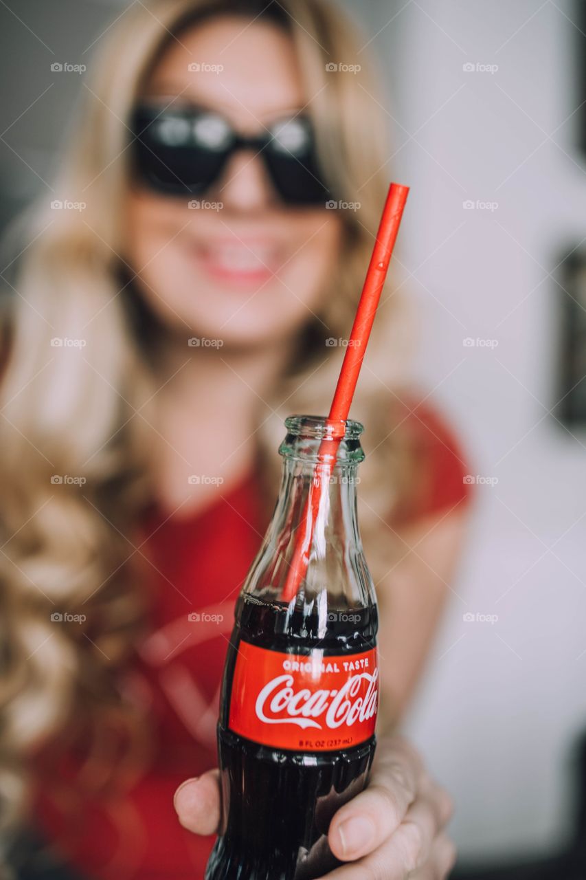 Girl drinking Coca Cola 