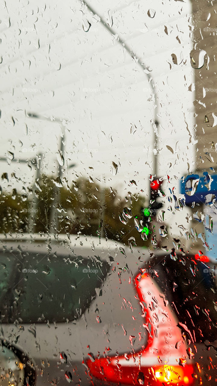 Raindrops on the window with blurred street background.