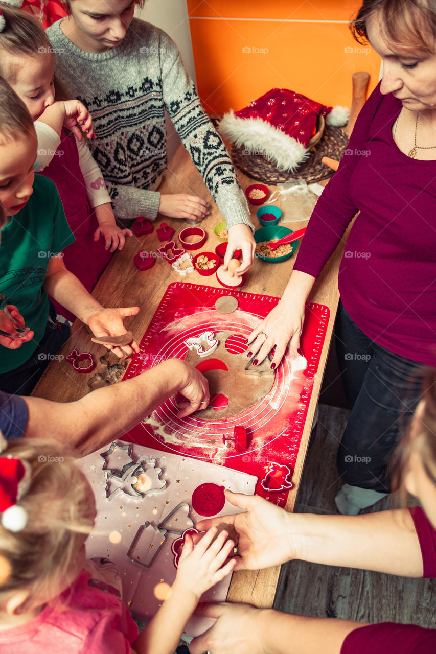 Baking Christmas cookies. Christmas gingerbread cookies in many shapes decorated with colorful frosting, sprinkle, icing, chocolate coating, toppers, put on table. Baking traditional cookies. Family celebrating Christmas. Baking at home