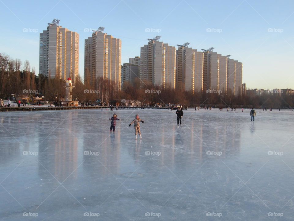 ice-bound river, winter evening, ice skating rink