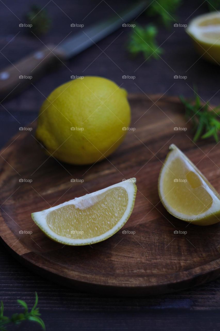 Fresh lemon on a wooden plate
