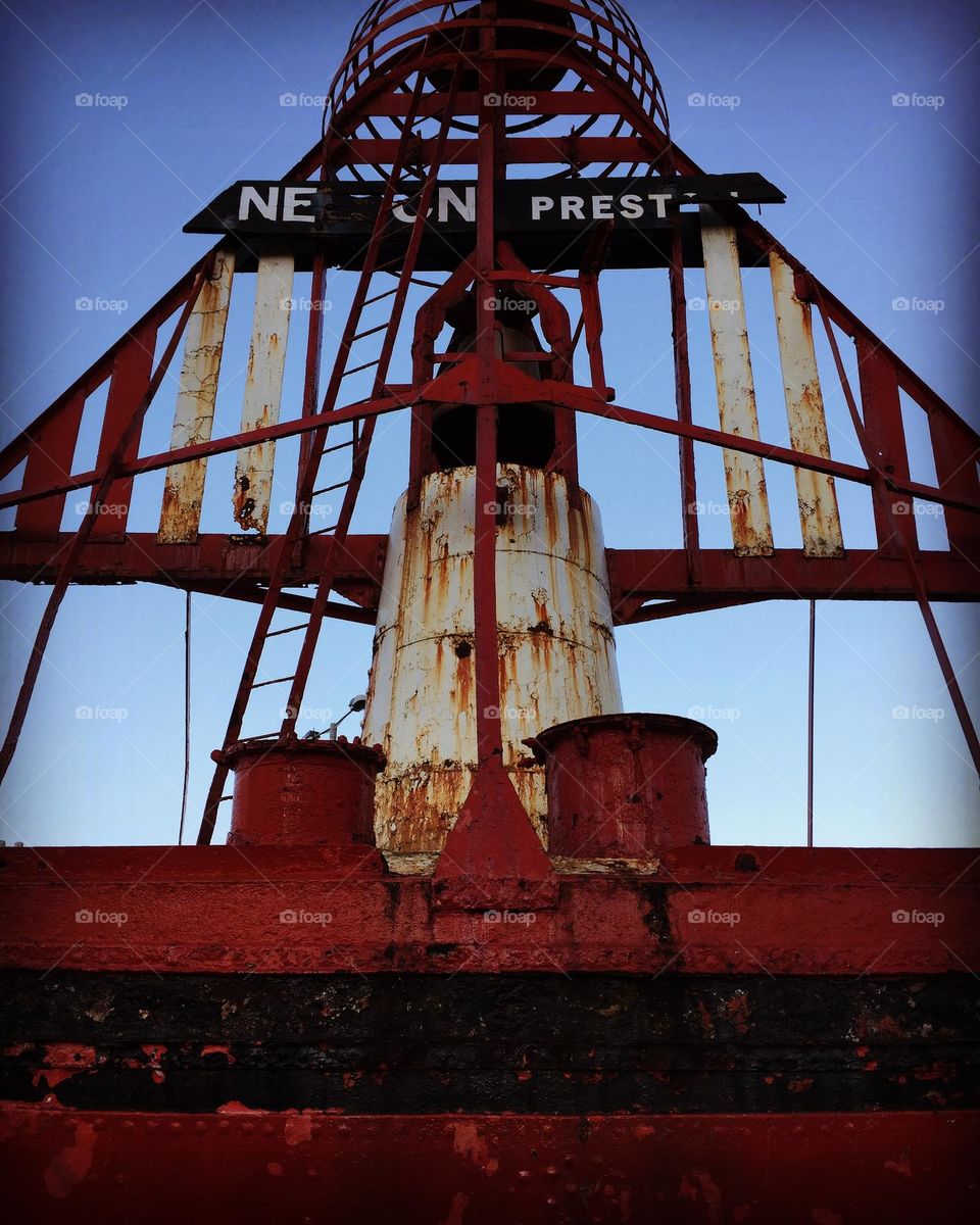 On the shore, metal buoys, rusted metal buoys, damaged metal 