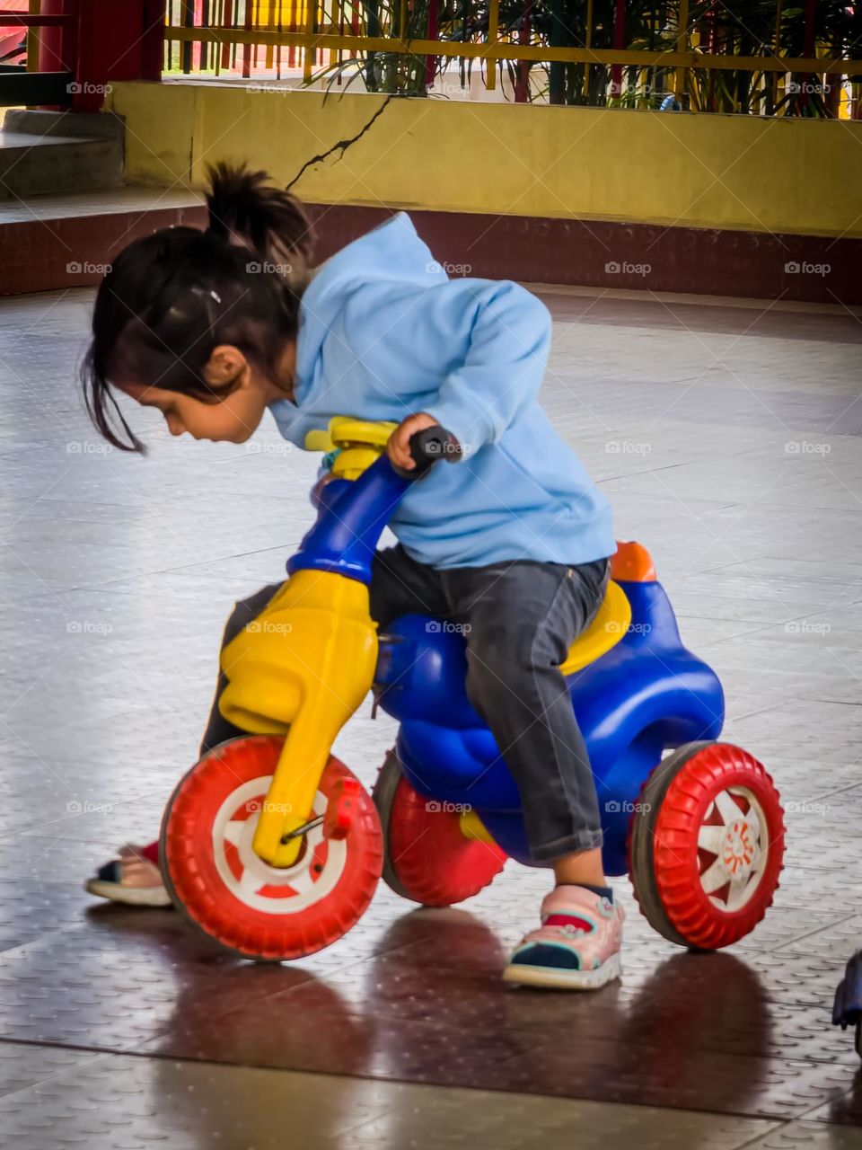 Cute little kid playing on a scooter