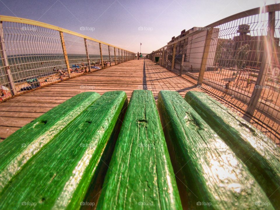 Summer. Sea. Green bench on a pier. sunny day.
