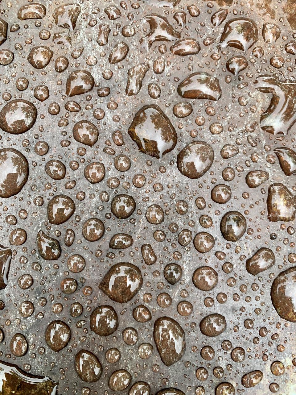 iron foil wet with water with large drops highlighted to form a texture