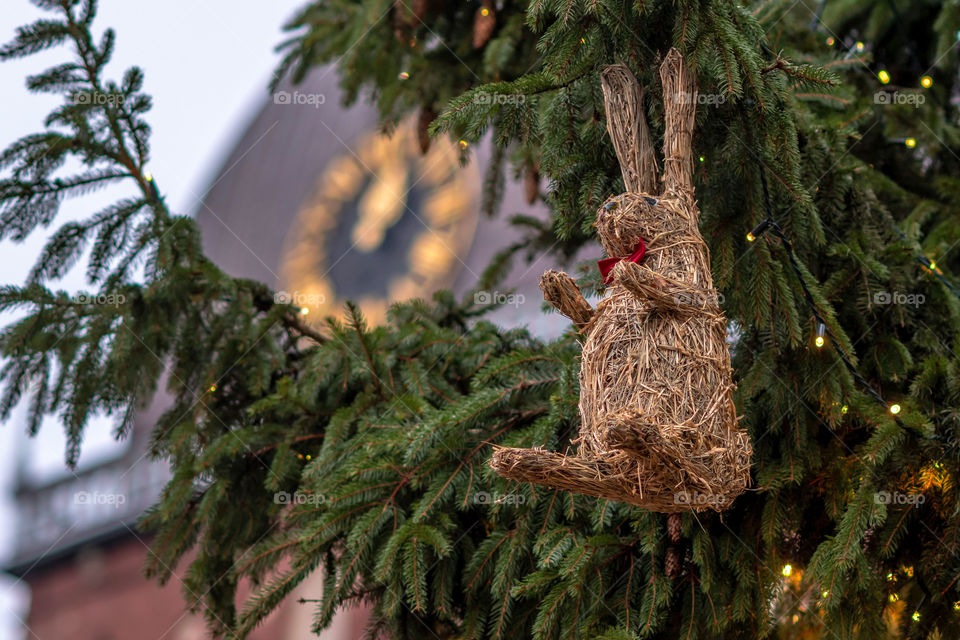 Clock in church tower. In the foreground Christmas decorations and lights,